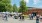 a group of people walking near a farmer's market